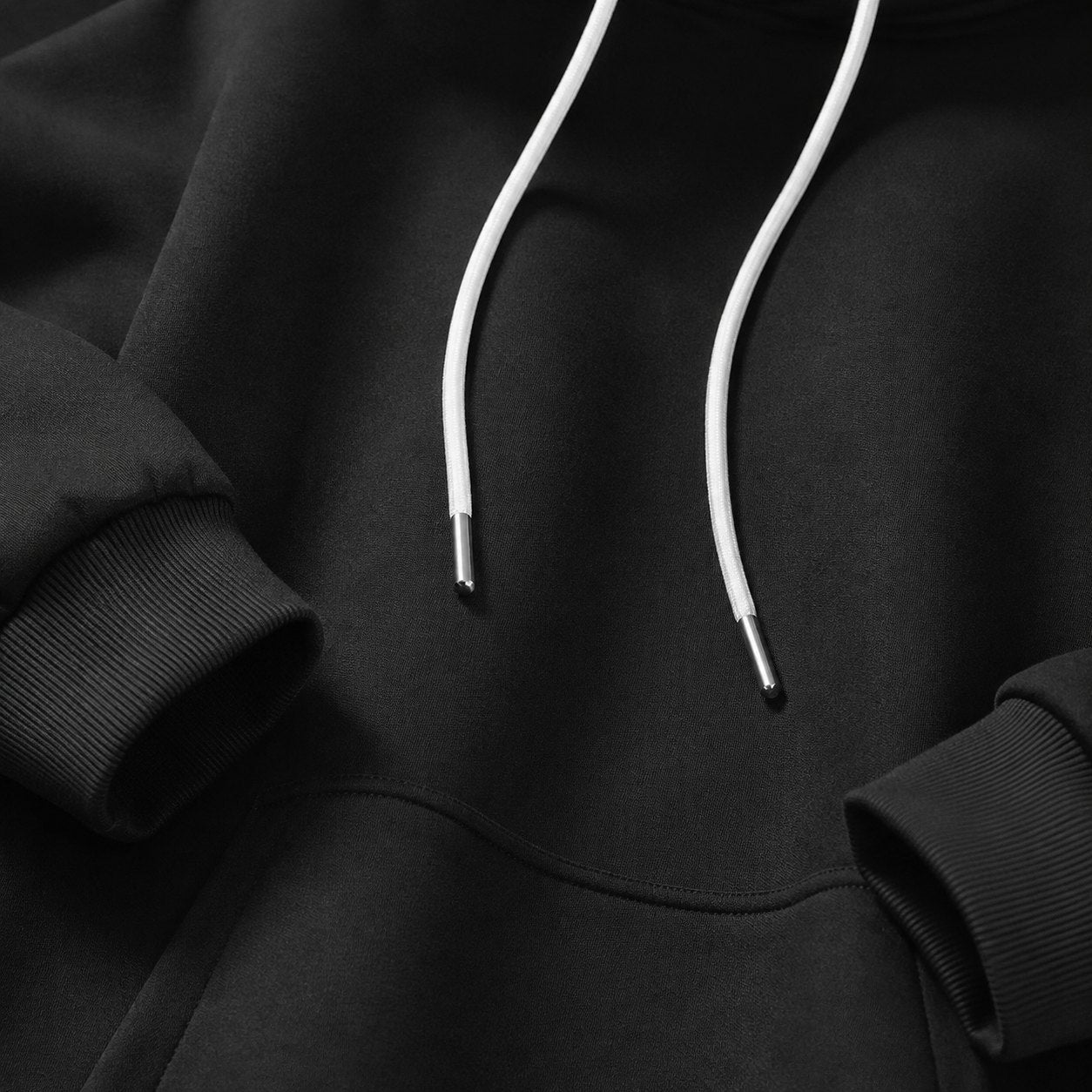 Close-up of Warmyās smooth outer fabric, drawstrings and pocket seam