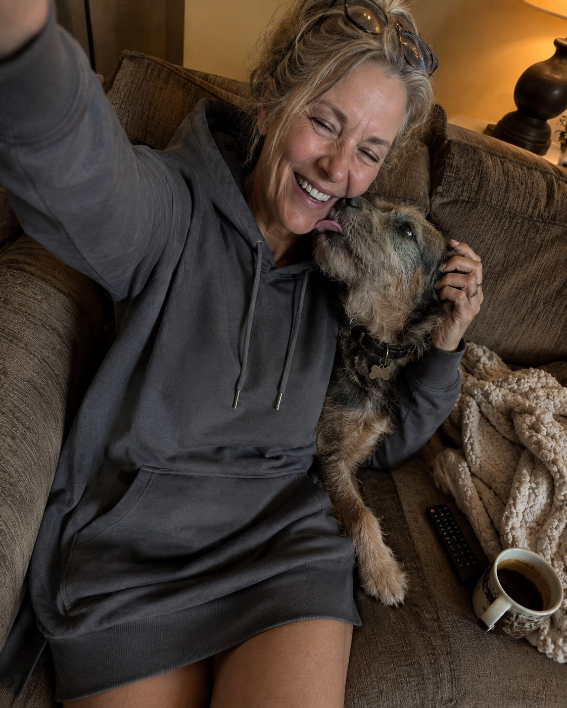 Woman resting at home in a Warmy hoodie dress